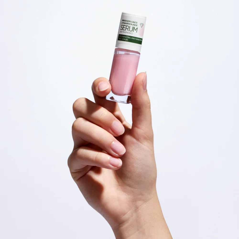 Hand holding the Eveline Nail Therapy Professional nail serum 8ml bottle