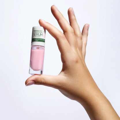 Hand holding the Eveline Nail Therapy Professional regenerating and hardening nail serum 8ml bottle